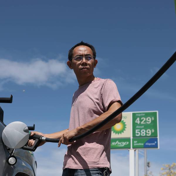 man puts fuel in his vehicle in florida