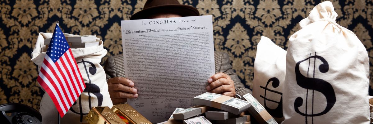 Man reading US Constitution surrounded by money.