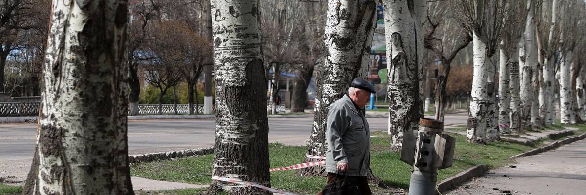 Man walks by cluster munition