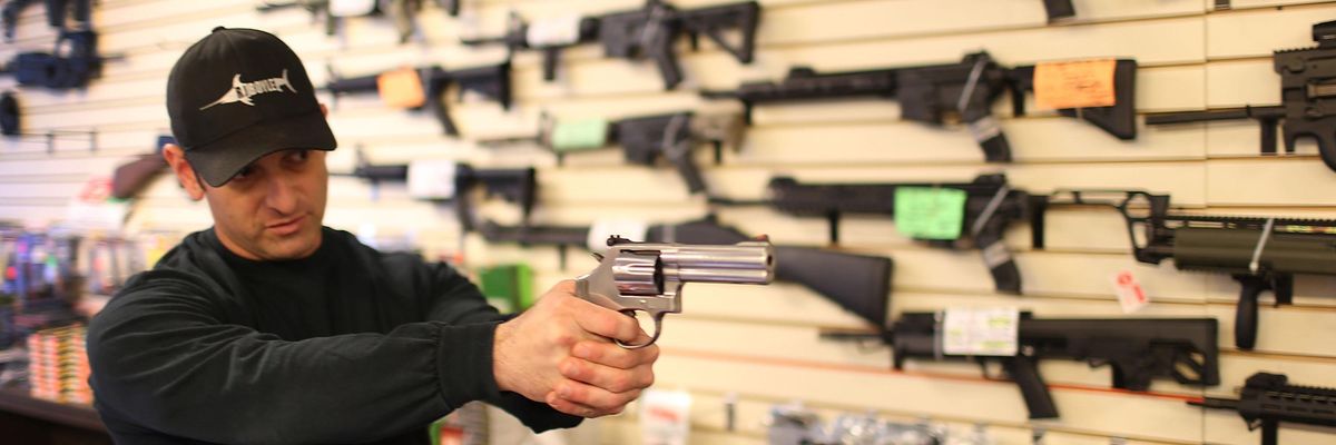 Man with a gun in gun store