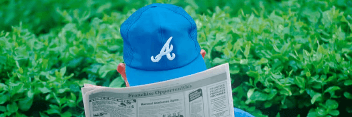 Man with hat reading newspaper