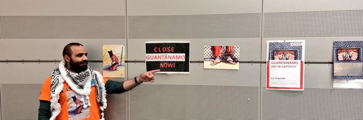 Mansoor Adayfi points to art.