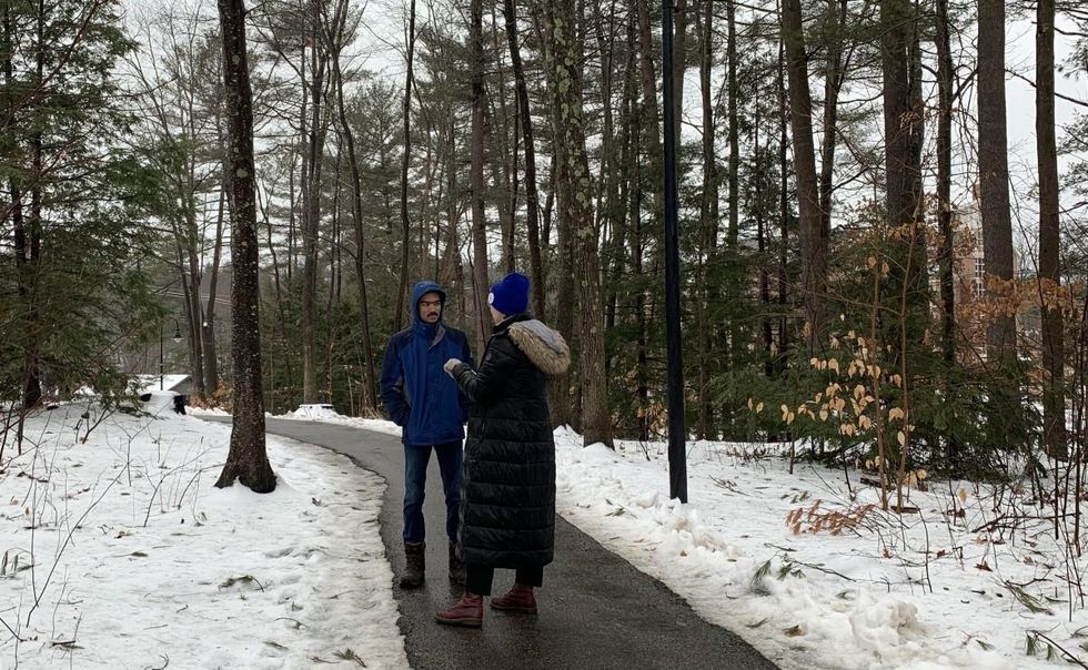 Marcela Mulholland of the Sunrise Movement talks to an Andrew Yang supporter on UNH campus Monday.