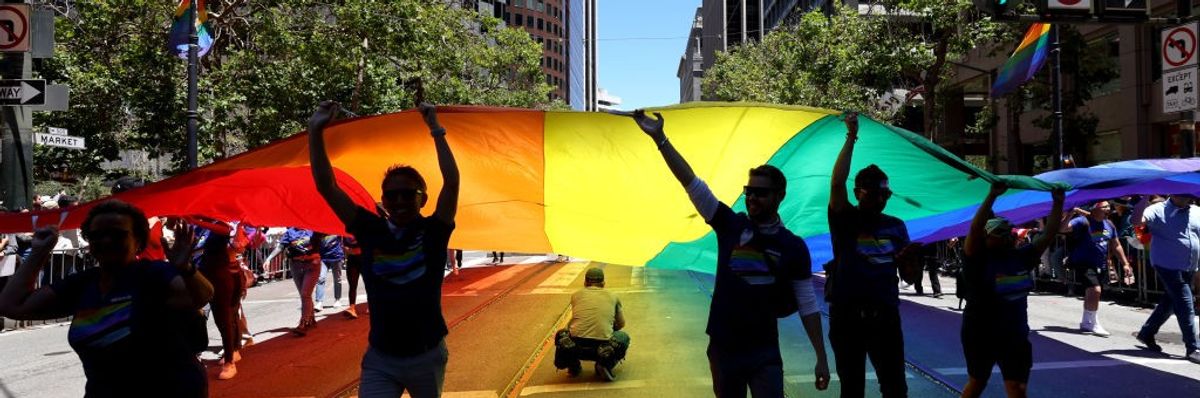 Marchers carry an oversized Pride flag during the 52nd annual San Francisco Pride Parade and Celebration on June 26, 2022