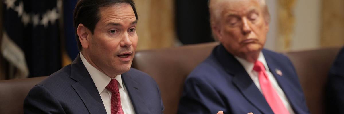 Marco Rubio speaks while Donald Trump looks on
