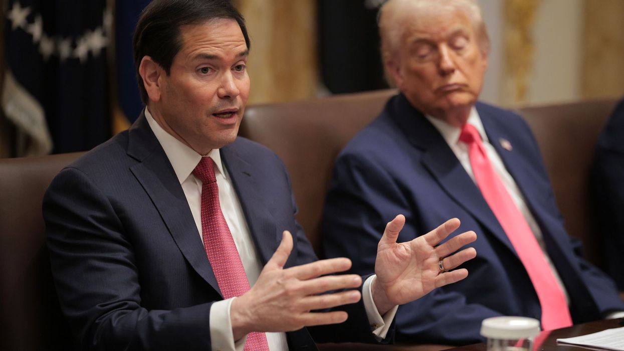 Marco Rubio speaks while Donald Trump looks on