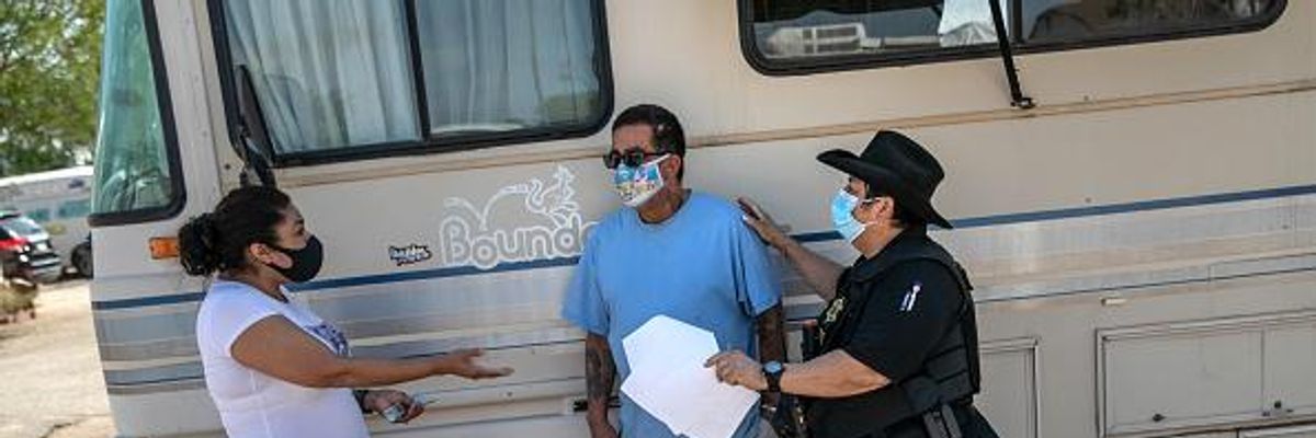 Maricopa County constable Darlene Martinez brokers a deal between tenant Hector Medrano, who was only able to forestall eviction thanks to a last-minute salary advance, and landlord Teodora Carcia at an RV park on October 7, 2020 in Phoenix, Arizona.