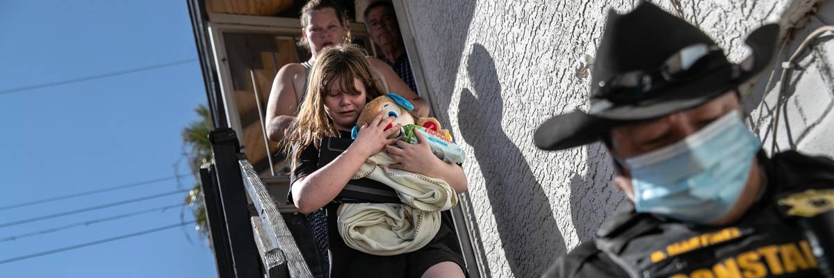 Maricopa County constable Darlene Martinez escorts a family out of their apartment after serving an eviction order for non-payment of rent on September 30, 2020 in Phoenix. (Photo: John Moore via Getty Images)