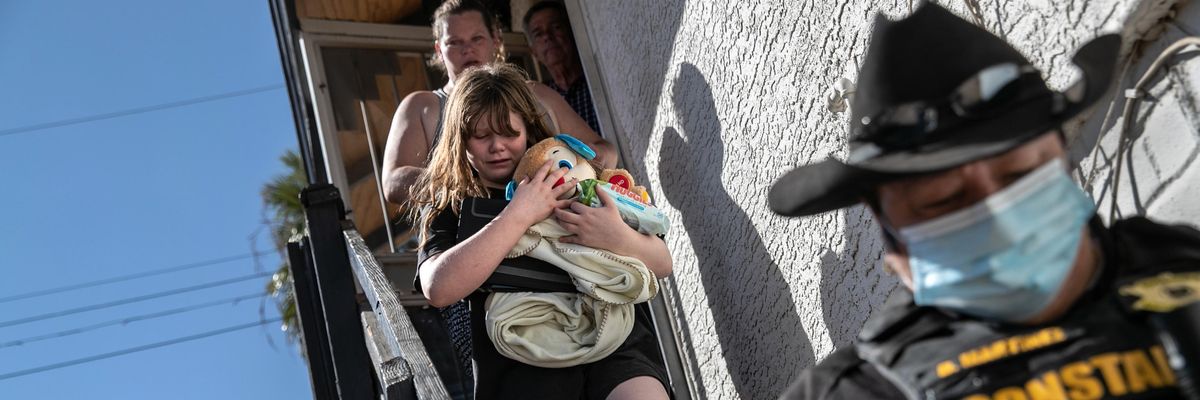 Maricopa County constable Darlene Martinez escorts a family out of their apartment after serving an eviction order for non-payment of rent on September 30, 2020 in Phoenix. (Photo: John Moore via Getty Images)