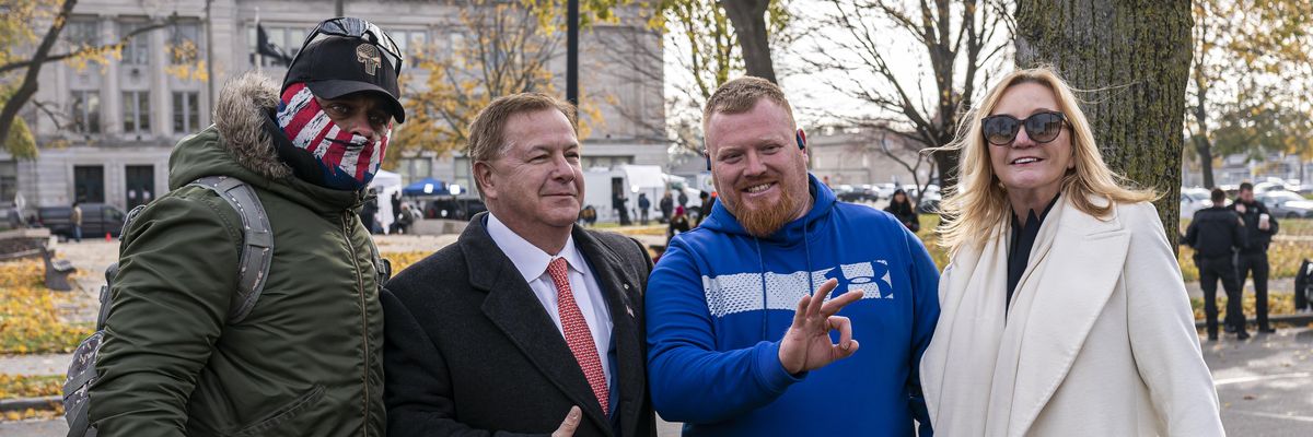 Mark McCloskey, center left, a Republican candidate for U.S. Senate in Missouri who first garnered attention in June 2020 after pointing guns at Black Lives Matter protesters outside his house in a gated community in St. Louis, poses with supporters of Kyle Rittenhouse and his wife Patricia McCloskey in front of the Kenosha County Courthouse while the jury deliberates the Rittenhouse trial on November 16, 2021 in Kenosha, Wisconsin.