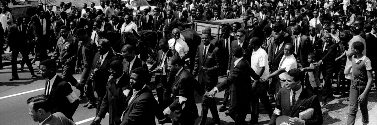 Martin Luther King's casket, borne on a mule-drawn cart, moves through Atlanta