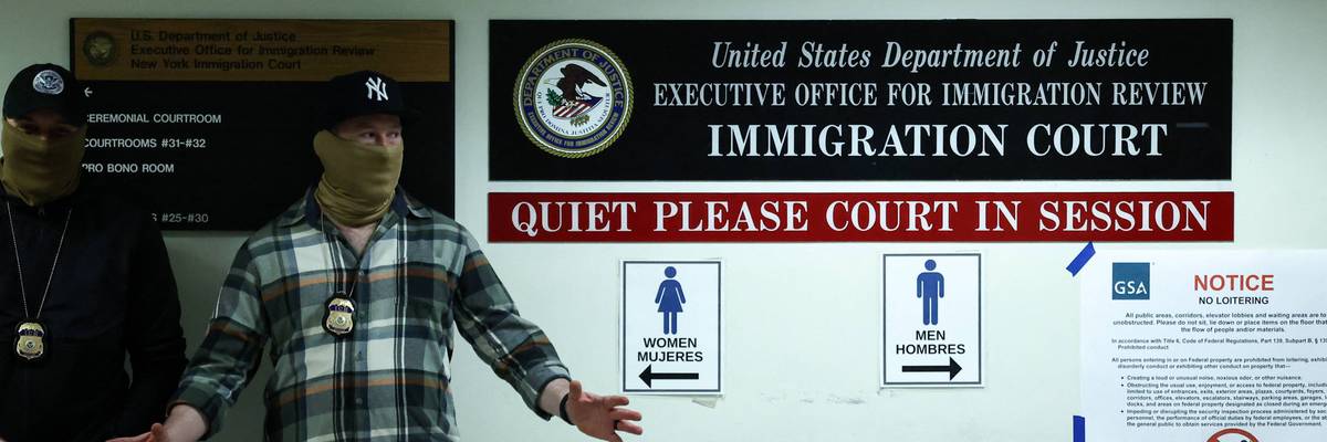 Masked federal agents stand in a hallway at the New York Federal Plaza Immigration Court
