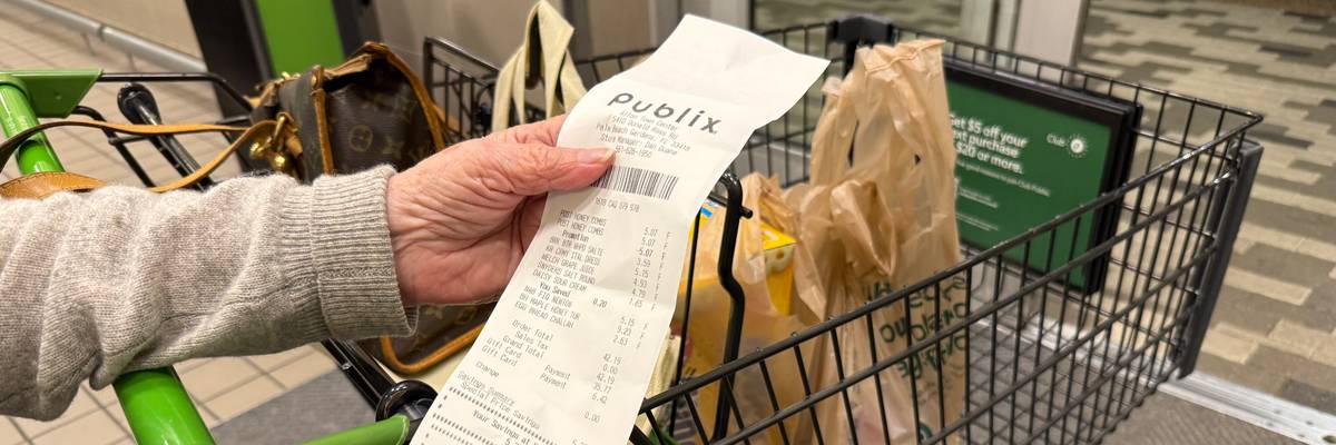 Mature woman reviewing receipt after shopping at Publix supermarket, Florida