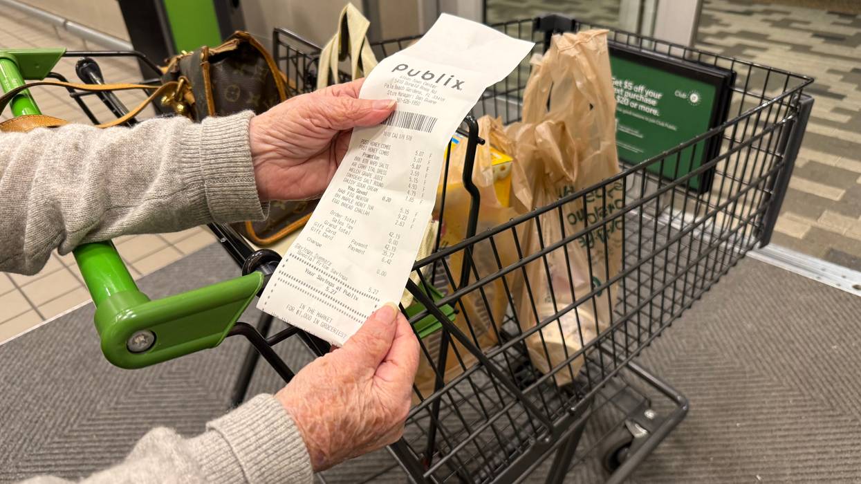 Mature woman reviewing receipt after shopping at Publix supermarket, Florida