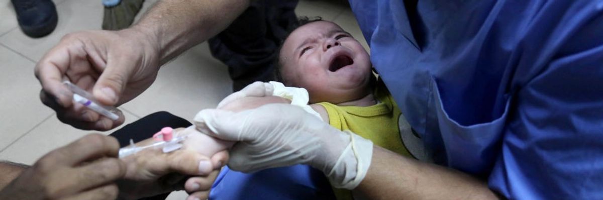 Medical staff treat an injured Palestinian baby