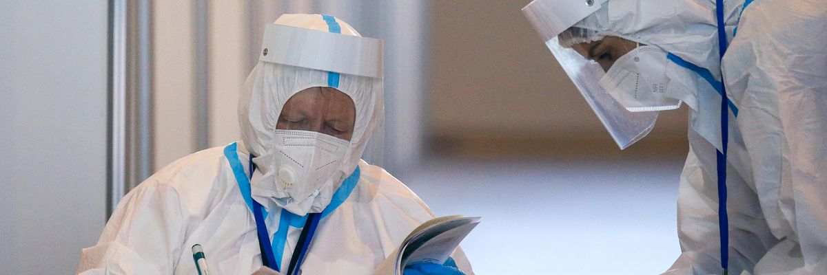 Medical workers examine paperwork