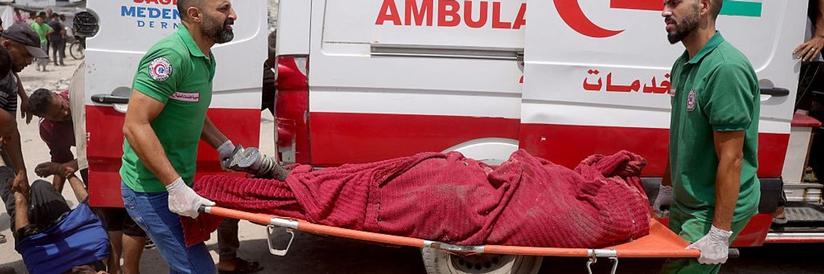 Medics carry victim of Israel bombardment in Gaza.