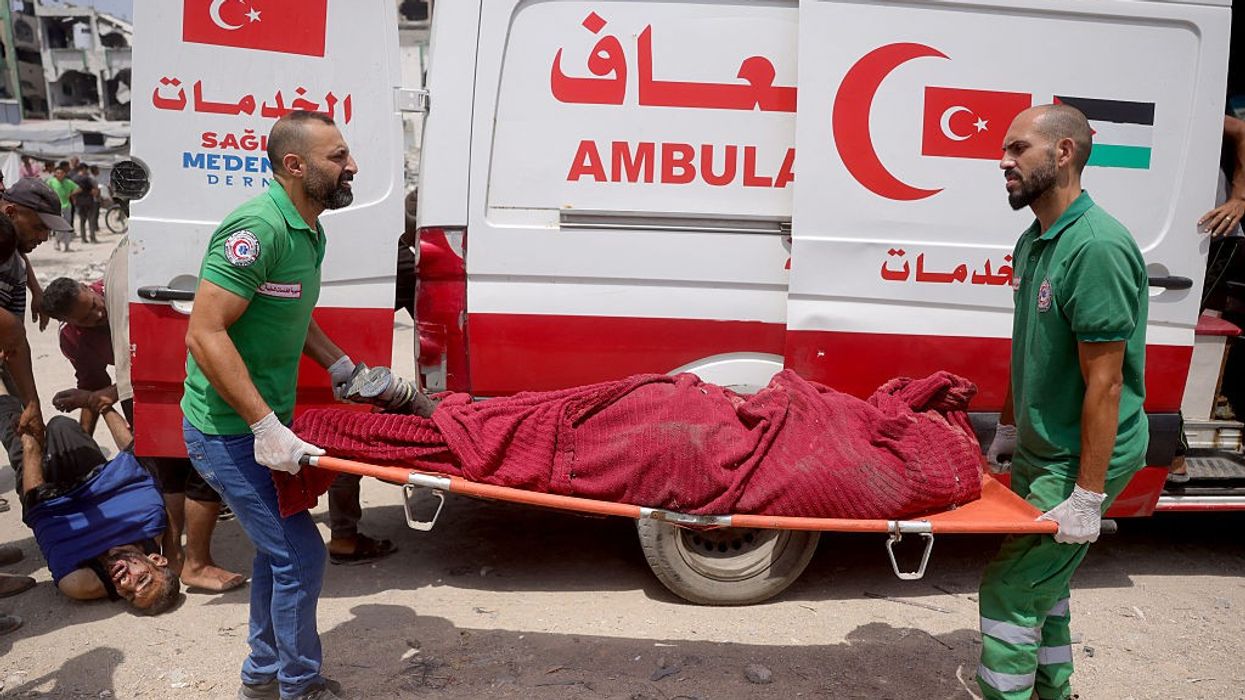 Medics carry victim of Israel bombardment in Gaza.