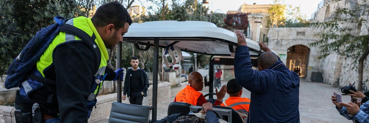 Medics transport an injured Palestinian man to the hospital