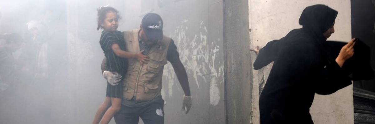 Members of a Palestinian family rush out of a bombed house