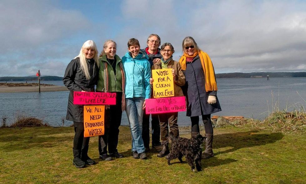 Members of Community Rights San Juan Islands hold up signs to show support for the Lake Erie Bill of Rights, which passed, in February 2019. (Photo: Ani Sandburn-Bill)
