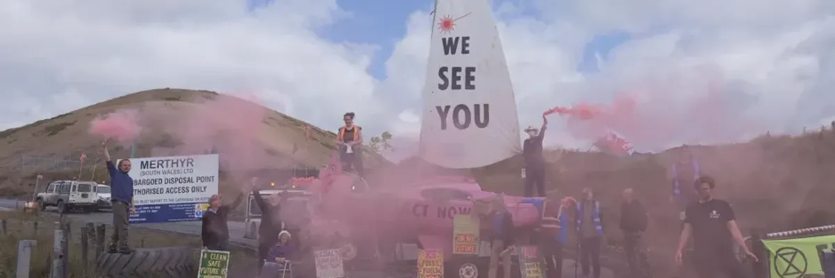 Members of Extinction Rebellion locked themselves to the group's pink boat, which was used to blockade the access road between the Ffos-y-Fran mine and its depot​ in South Wales on July 5, 2023.