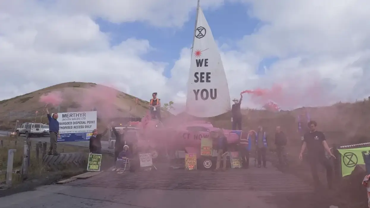 Members of Extinction Rebellion locked themselves to the group's pink boat, which was used to blockade the access road between the Ffos-y-Fran mine and its depot in South Wales on July 5, 2023.