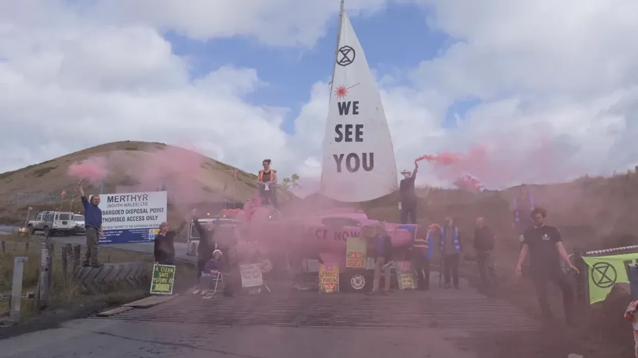 Members of Extinction Rebellion locked themselves to the group's pink boat, which was used to blockade the access road between the Ffos-y-Fran mine and its depot in South Wales on July 5, 2023.