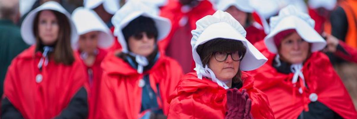 One Hundred 'Handmaids' Greet Mike Pence to Protest GOP's Anti-Choice Agenda