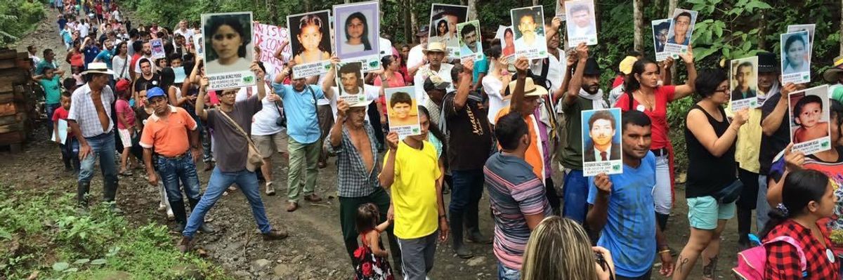 Members of the Comunidad de Paz de San Jose de Apartado march in memory of victims of the continuing violence in Colombia.