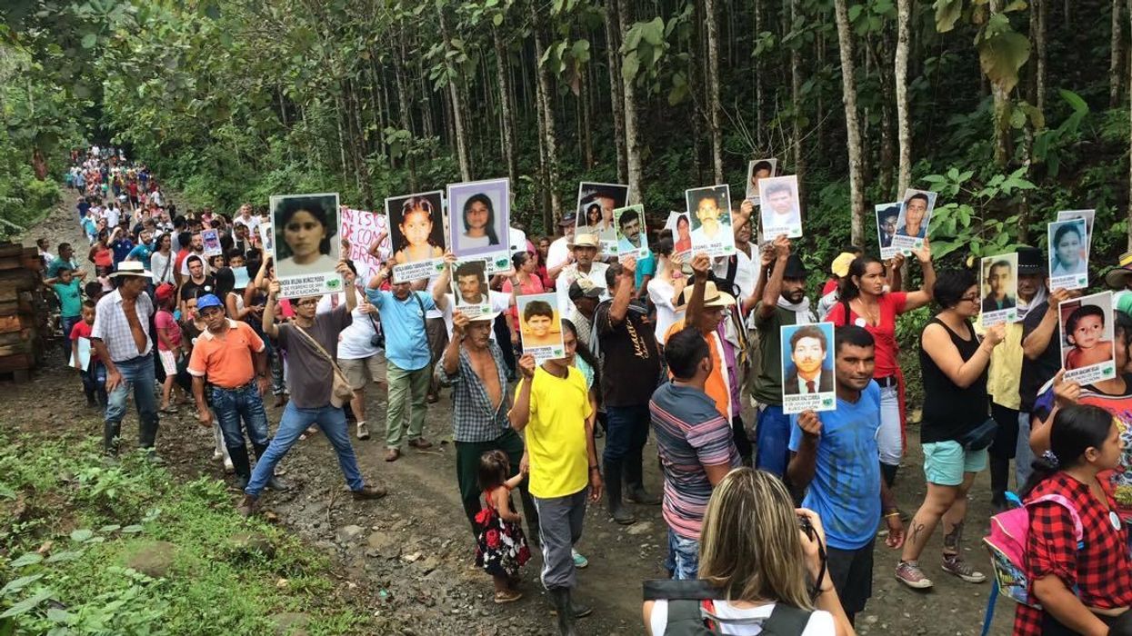 Members of the Comunidad de Paz de San Jose de Apartado march in memory of victims of the continuing violence in Colombia.