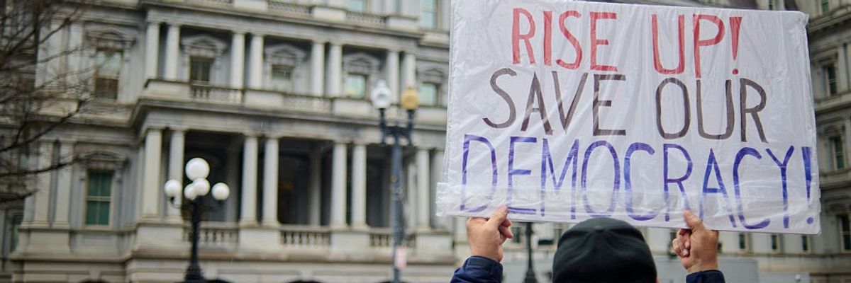 Members of the Consumer Financial Protection Bureau protest outside the Eisenhower Executive Office Building