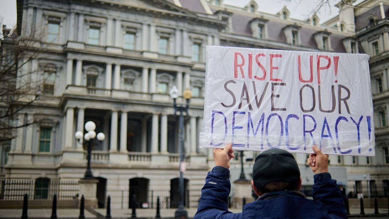 Members of the Consumer Financial Protection Bureau protest outside the Eisenhower Executive Office Building