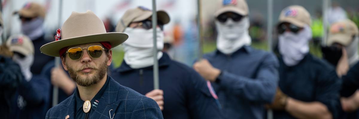 Members of the far-right Patriot Front listen as leader Thomas Rousseau speaks at the Washington Monument