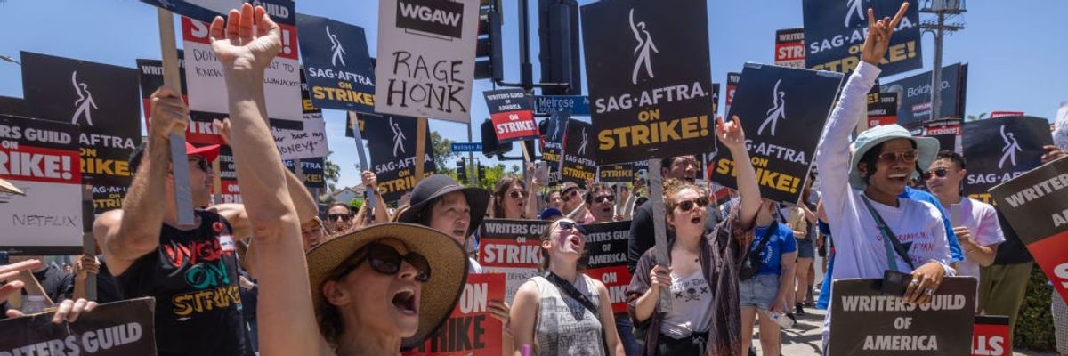 Members of the Hollywood actors SAG-AFTRA union walk a picket line with screenwriters outside of Paramount Studios on Day 2 of the actors' strike on July 14, 2023 in Los Angeles, California.