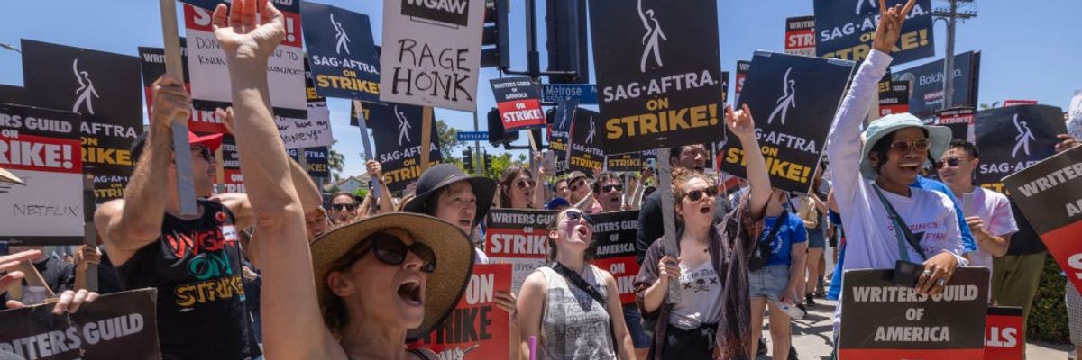 Members of the Hollywood actors SAG-AFTRA union walk a picket line with screenwriters outside of Paramount Studios on Day 2 of the actors' strike on July 14, 2023 in Los Angeles, California.