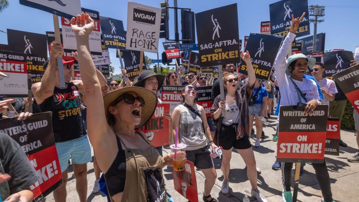 Members of the Hollywood actors SAG-AFTRA union walk a picket line with screenwriters outside of Paramount Studios on Day 2 of the actors' strike on July 14, 2023 in Los Angeles, California.
