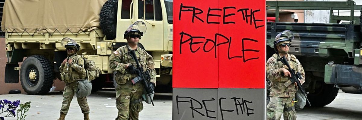 Members of the National Guard stand outside the Metropolitan Detention Center