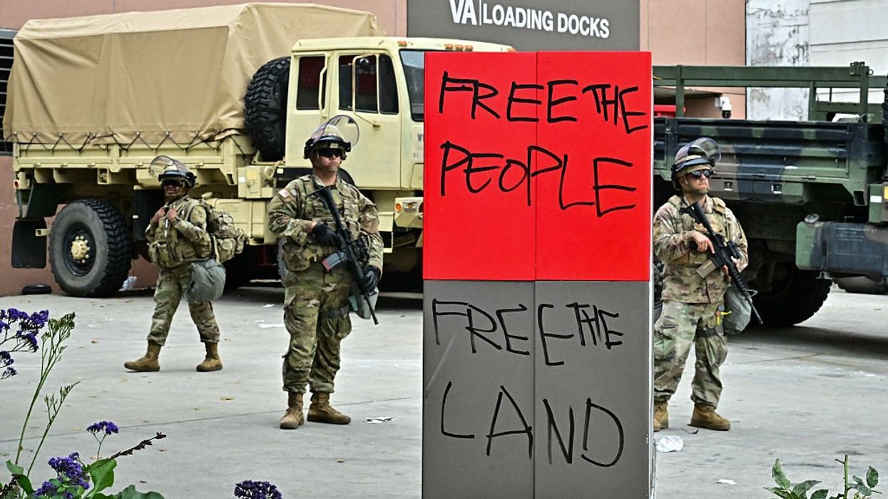 Members of the National Guard stand outside the Metropolitan Detention Center