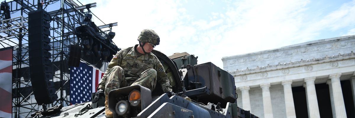 Members of the U.S. military are seen next to a Bradley Fighting Vehicle