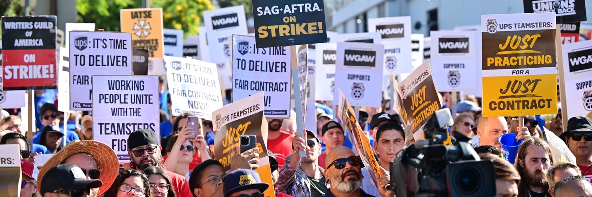 Members of the Writers Guild of America join UPS Teamsters during a rally