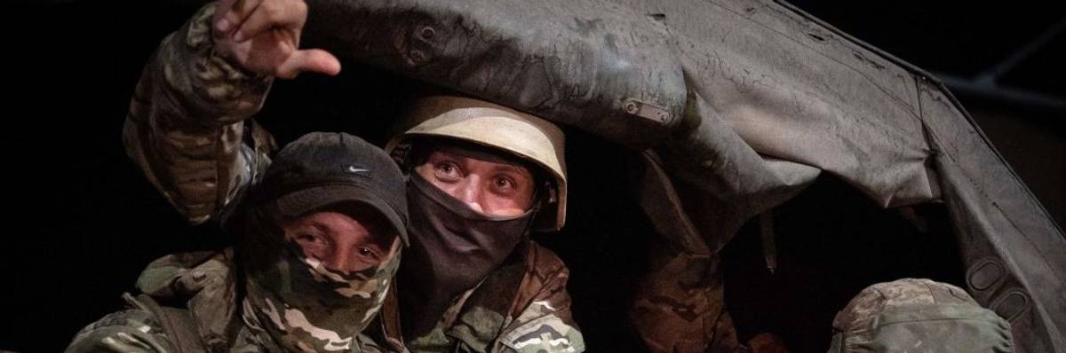 Members of Wagner group looks from a military vehicle in Rostov-on-Don
