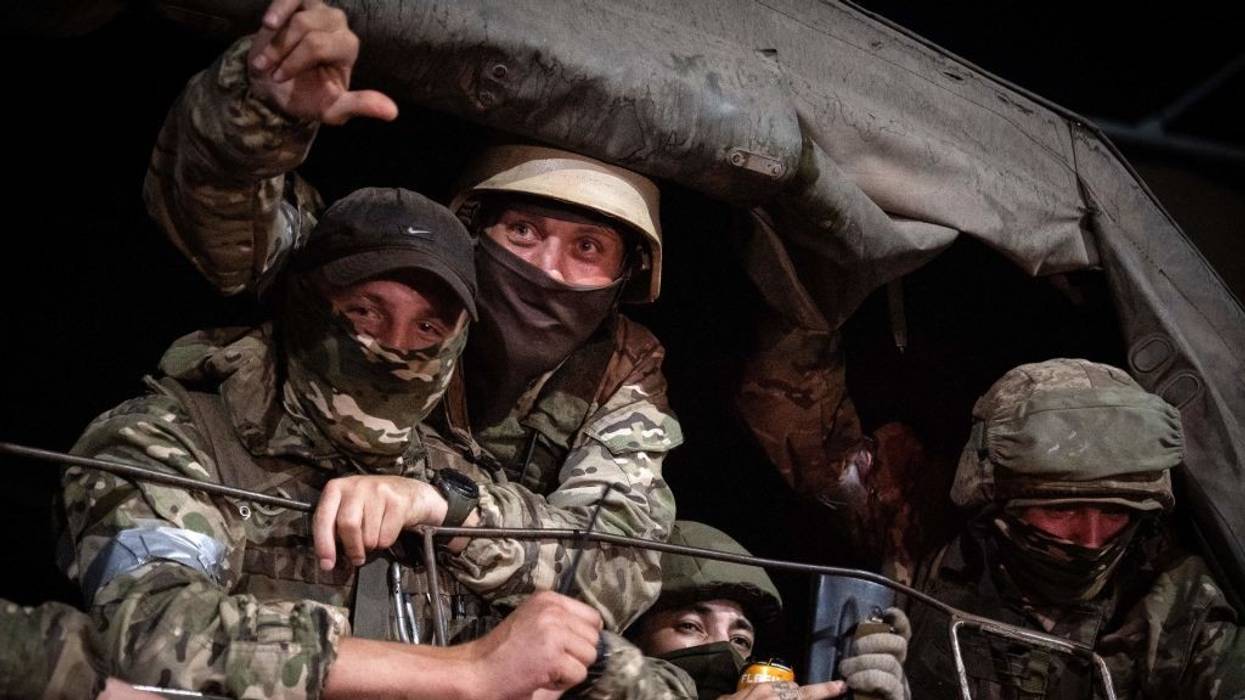 Members of Wagner group looks from a military vehicle in Rostov-on-Don