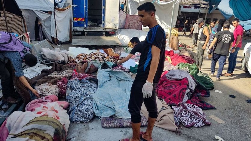 Men check bodies of bombing victims in Gaza.