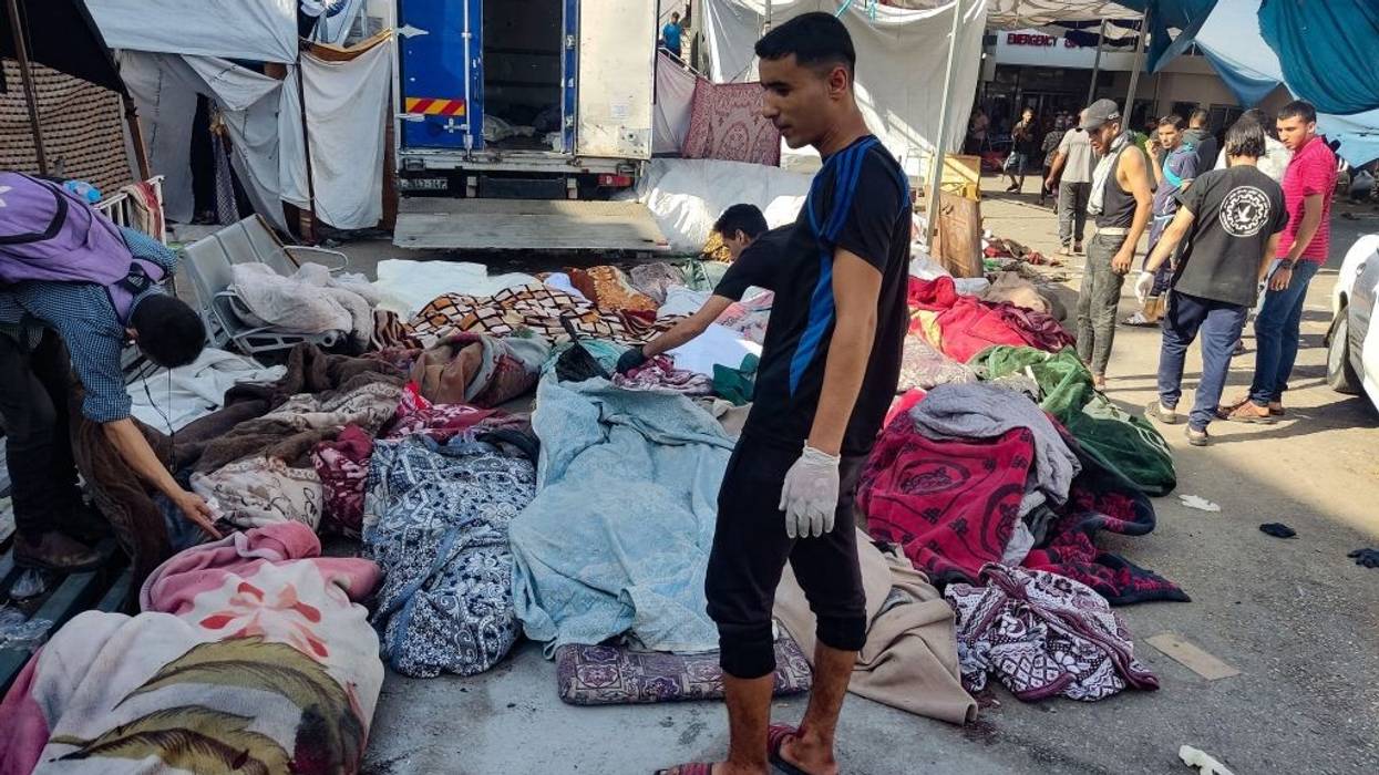 Men check bodies of bombing victims in Gaza.