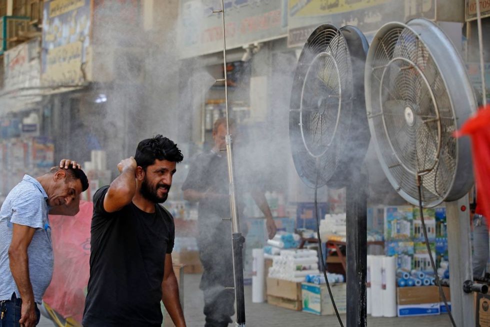 Men cool down in Baghdad heatwave.