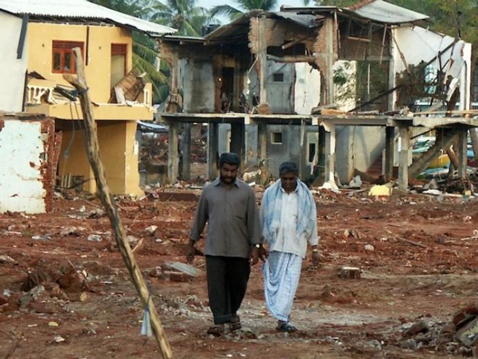 Men walk past destroyed buildings in the Hambantota town in southern Sri Lanka. Reconstruction in this town subsequently moved at a rapid pace. (Photo: Amantha Perera/IPS)