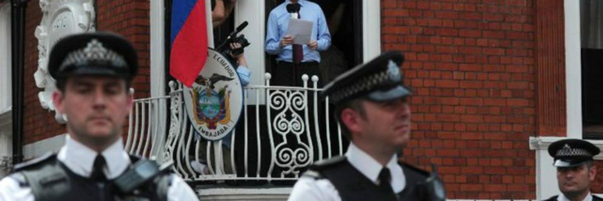 Met police stand outside the Ecuadorian embassy in London