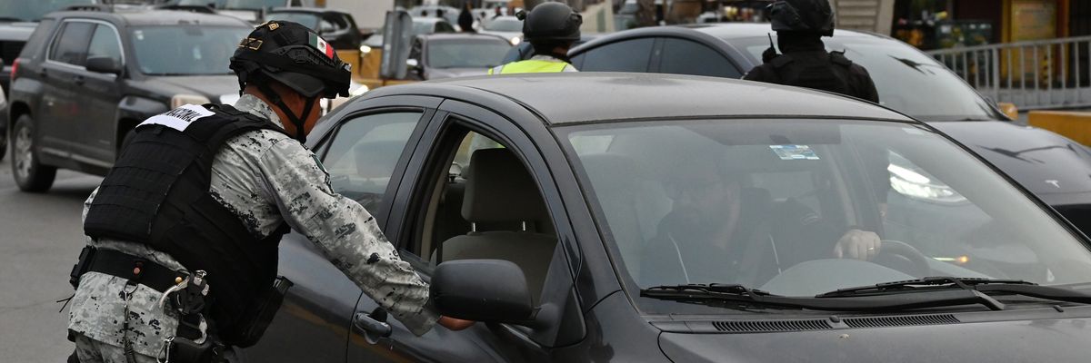 Mexican National Guard checking cars at U.S. border.