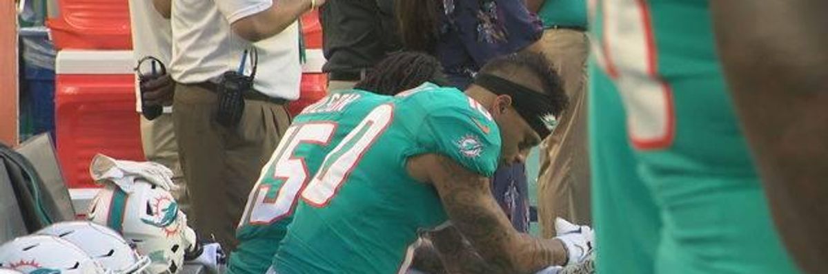 Miami Dolphins wide receivers Kenny Stills and Albert Wilson kneel during the national anthem